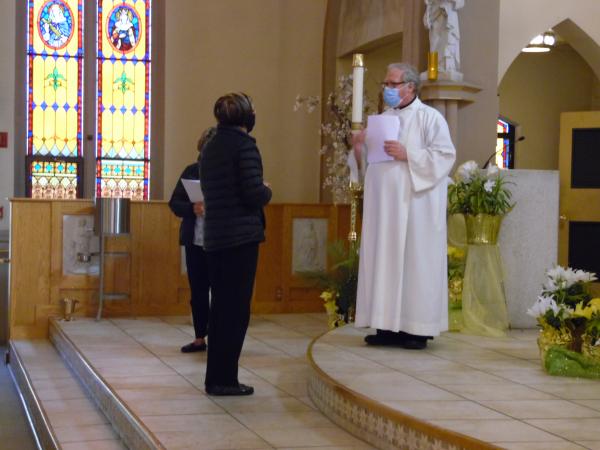 Fr. Pat Forman and Immediate Past Regent Lorraine Durfee install Diane Byrne as secretary at St. Monica's Church on May 13, 2021.